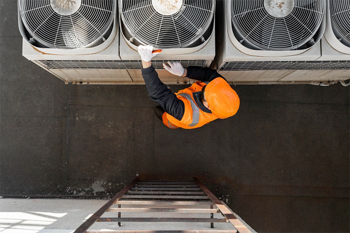 Worker servicing HVAC unit